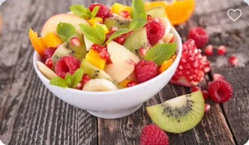 A bowl of fruit salad with berries and kiwi